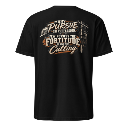 Back view of a black t-shirt featuring a lineman climbing a utility pole next to bold, stylized typography that reads, "Many pursue the profession, few possess the fortitude to live the calling." A hard hat and lightning bolt accent the design.